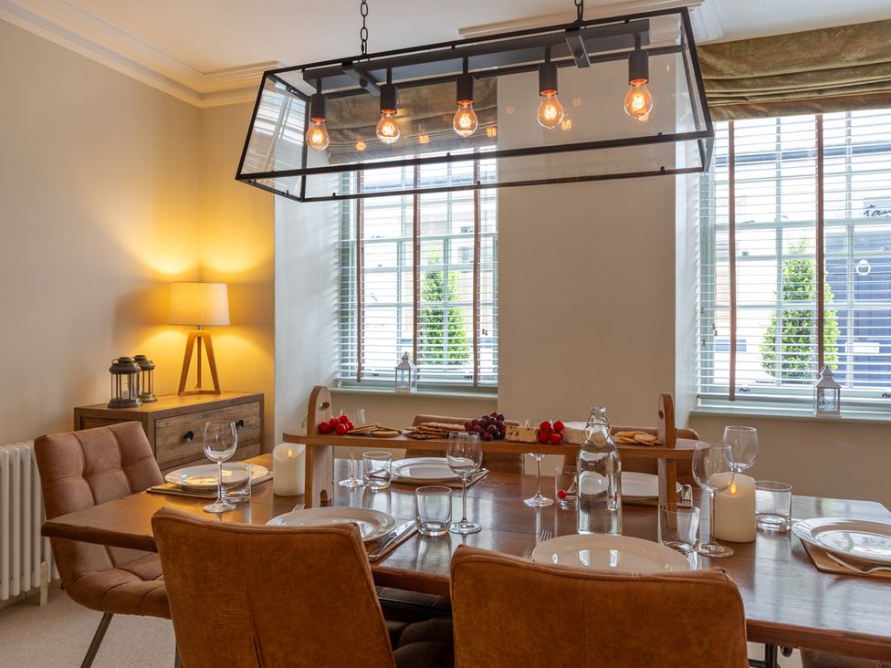 A dining room with a table set for a meal at George House in Dartmouth