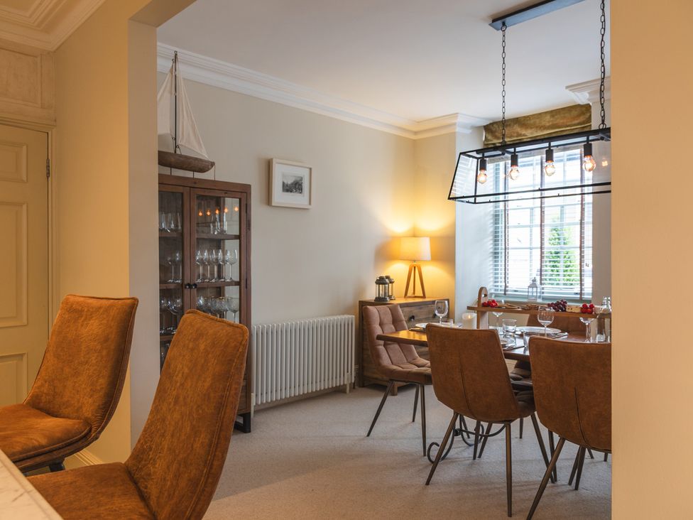 A dining room with a table and chairs at George House in Dartmouth