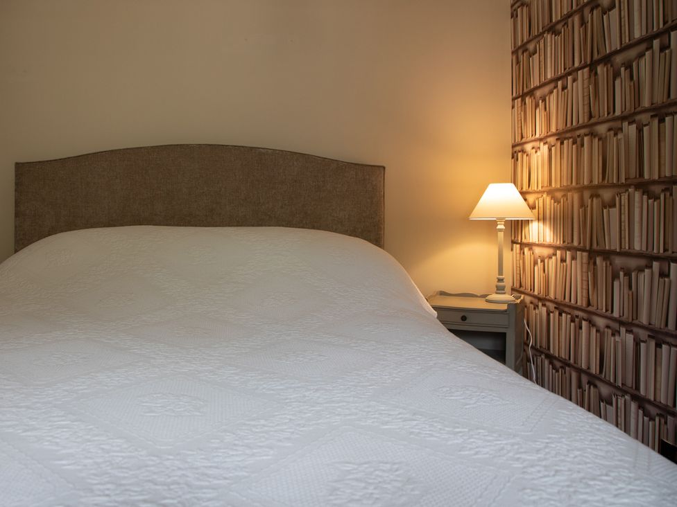 A bedroom with a bed and bedside lamp at George House Dartmouth