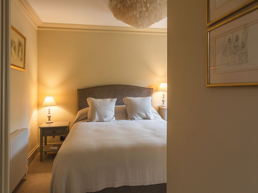 A bedroom with a bed and nightstand at George House in Dartmouth