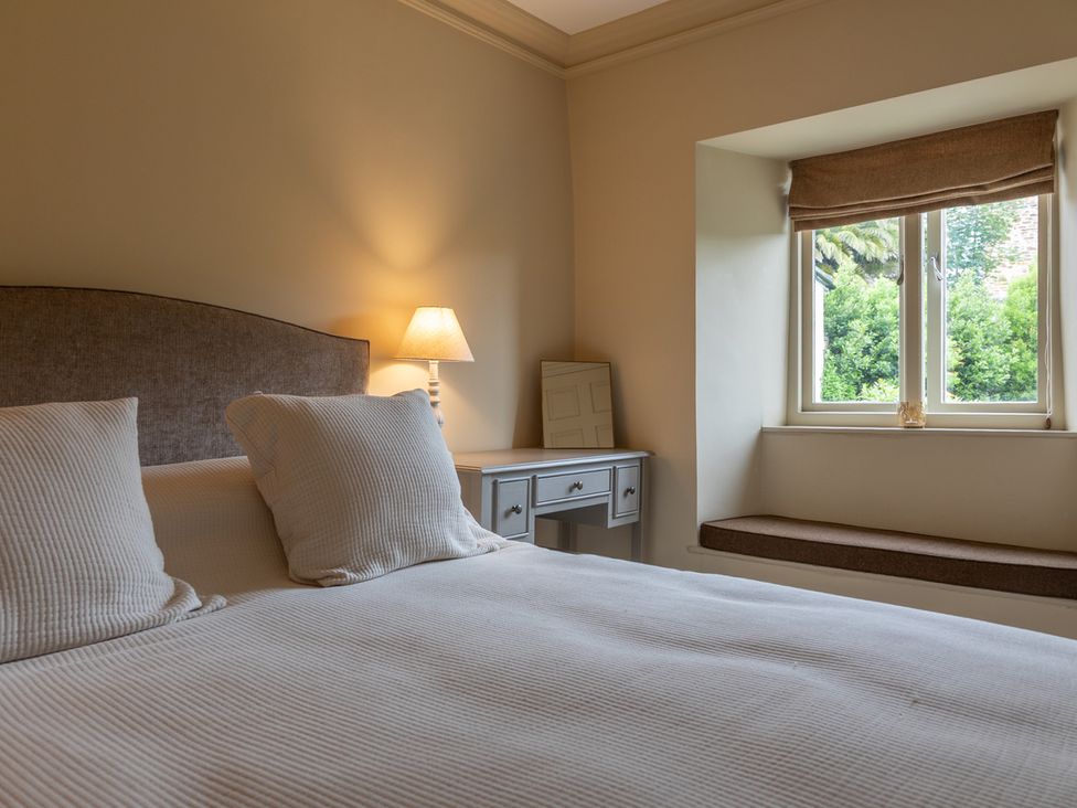 A bedroom with a bed and lamp at George House in Dartmouth