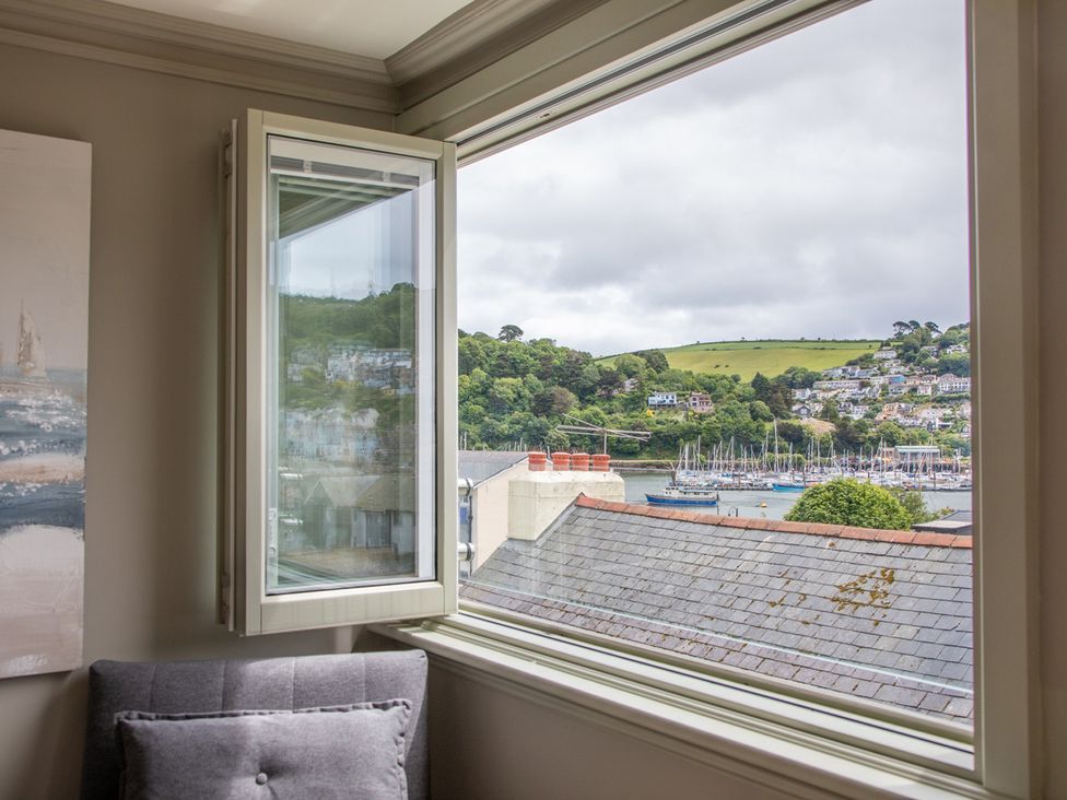 A living room window with a view of the harbor at George House in Dartmouth
