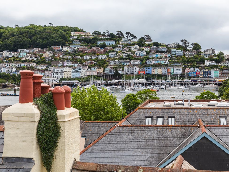 A view of rooftops and harbor with boats at George House in Dartmouth