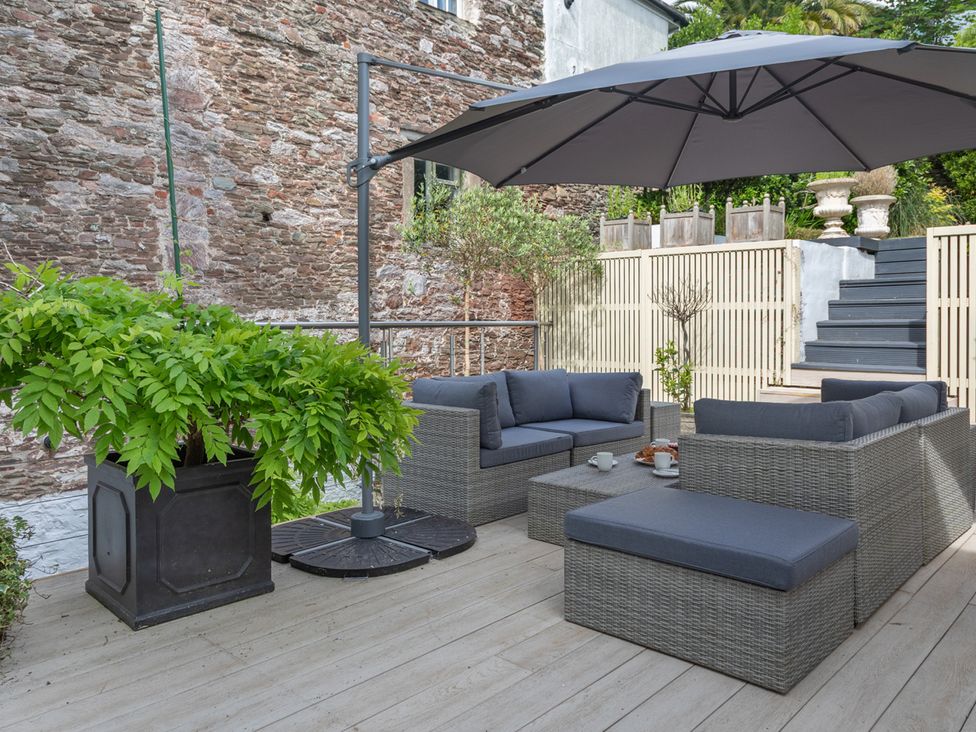 An outdoor seating area with a sofa and table at George House in Dartmouth