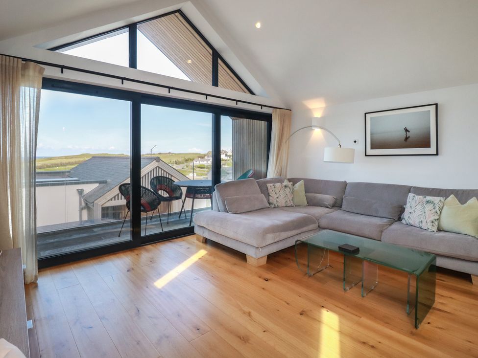 A living room with a sofa and coffee table at Porth Cove in Porth