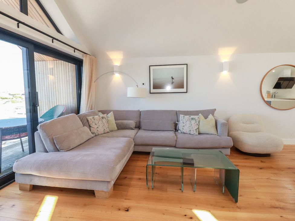 A living room with a sofa and coffee table at Porth Cove in Porth