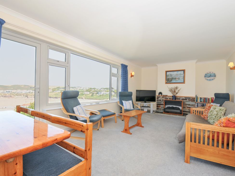 A living room with furniture and ocean view at Zapadiah in Polzeath