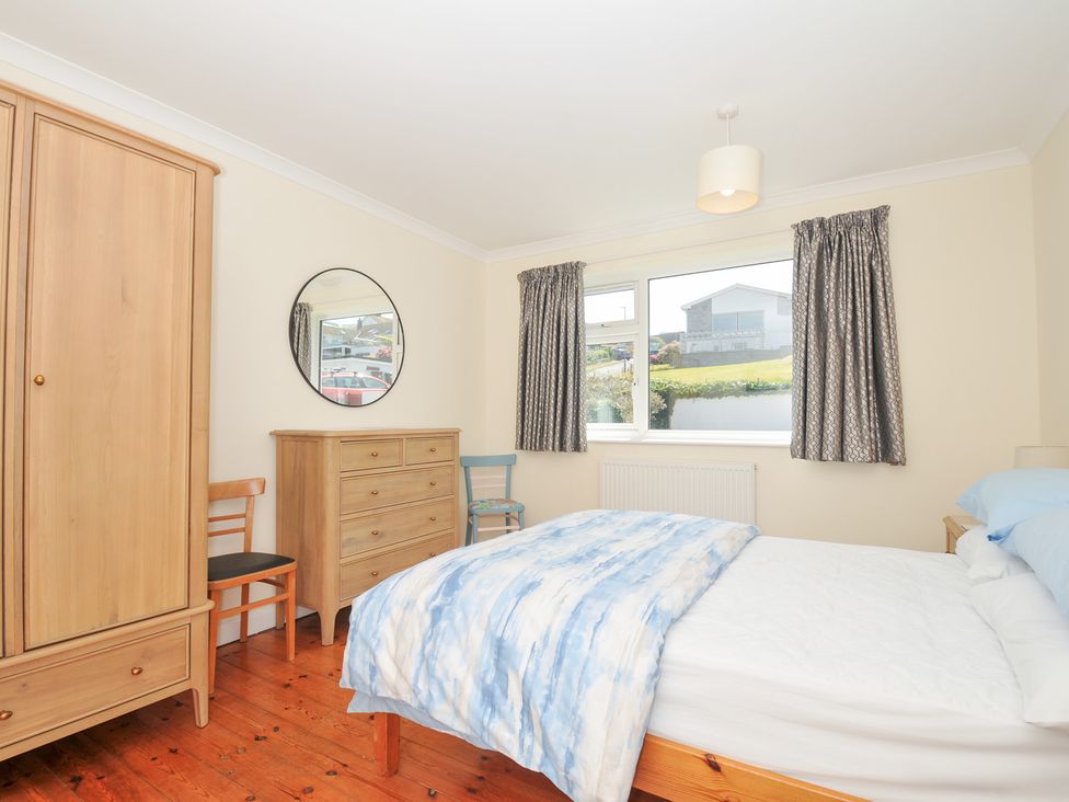 A bedroom with a bed and wardrobe at Zapadiah in Polzeath