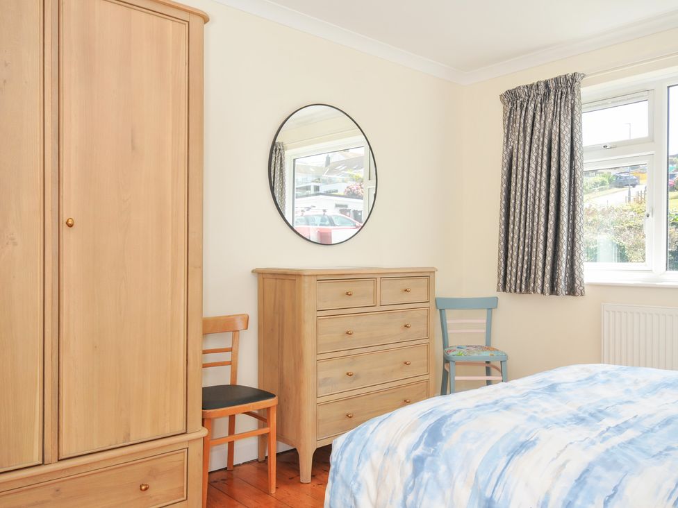 A bedroom with a wardrobe and chest of drawers at Zapadiah in Polzeath