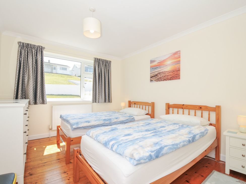 A bedroom with two beds and a window at Zapadiah in Polzeath