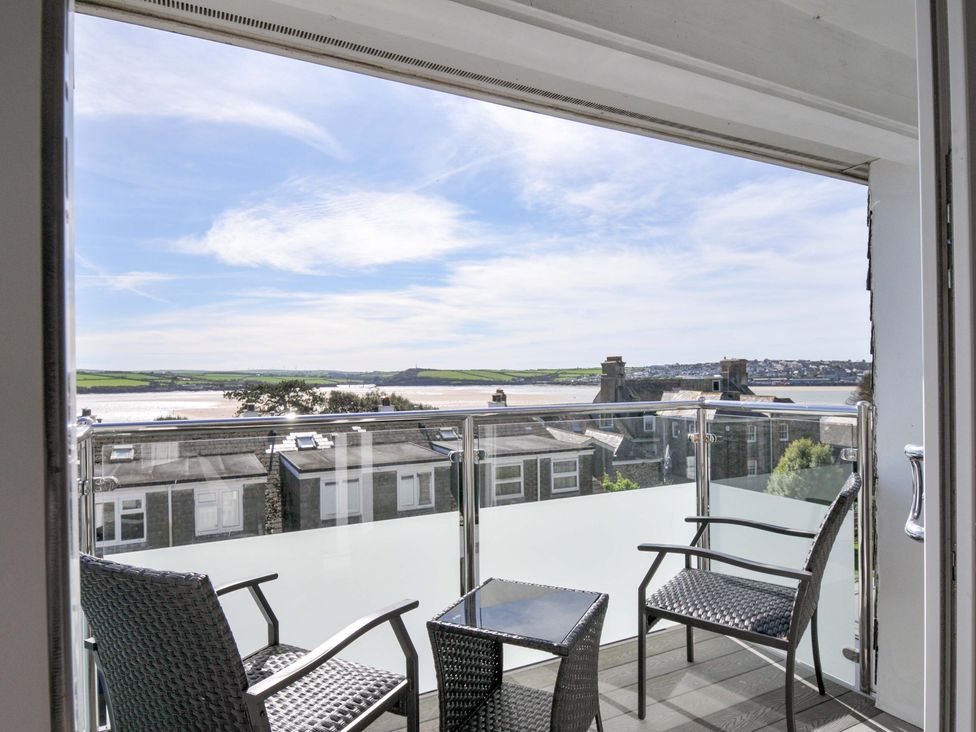 A balcony with chairs and a table overlooking the landscape at Slipway 15 Rock