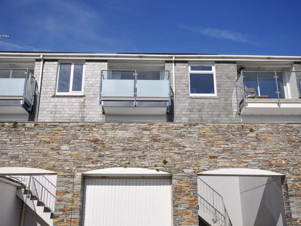 A building with balconies and a stone wall at Slipway 15 Rock