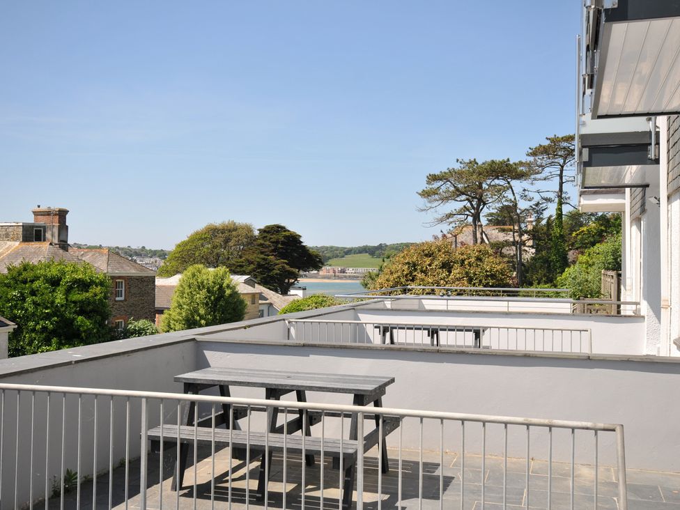 An outdoor terrace with a table and benches overlooking trees and distant buildings at Slipway 16 in Rock