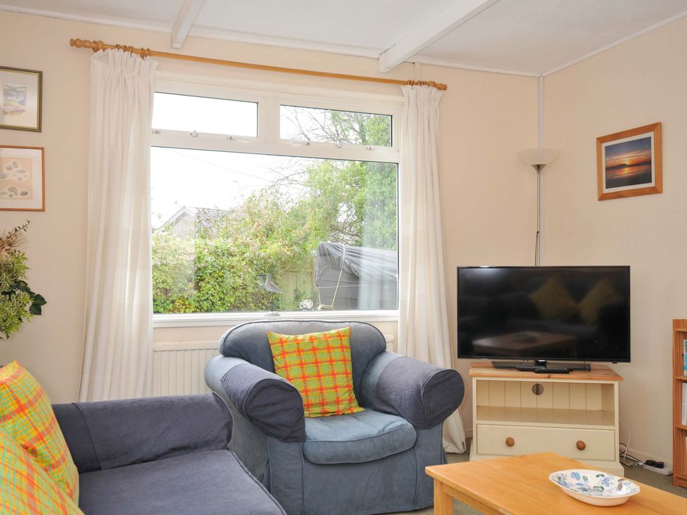 A living room with a sofa and television at Avoca in Rock