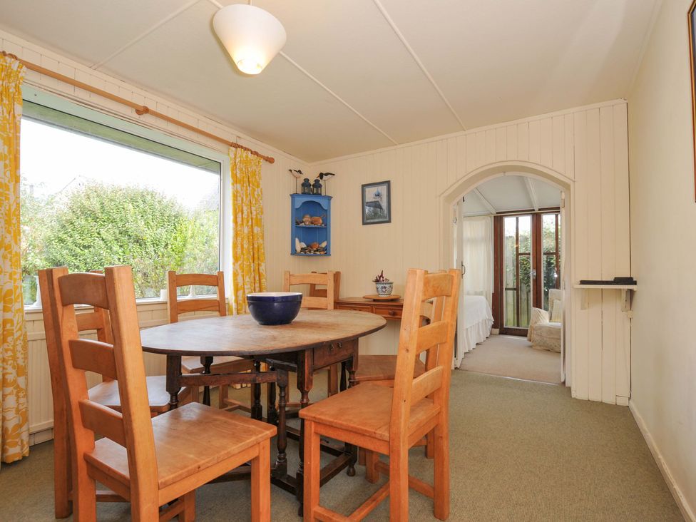 A dining room with a table and chairs at Avoca in Rock