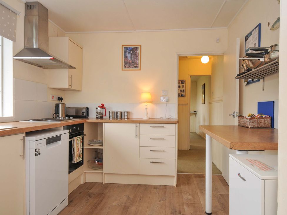 A kitchen with appliances and furniture at Avoca in Rock