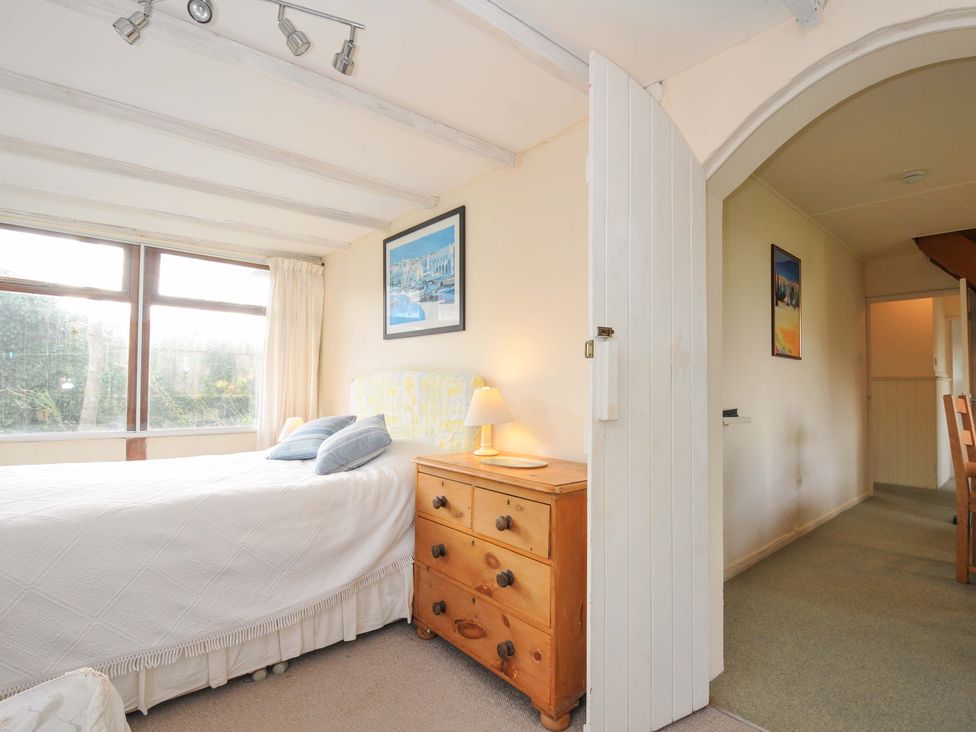 A bedroom with a bed and dresser at Avoca in Rock