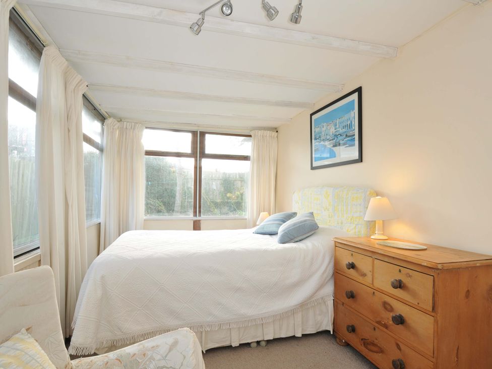 A bedroom with a bed and window at Avoca in Rock
