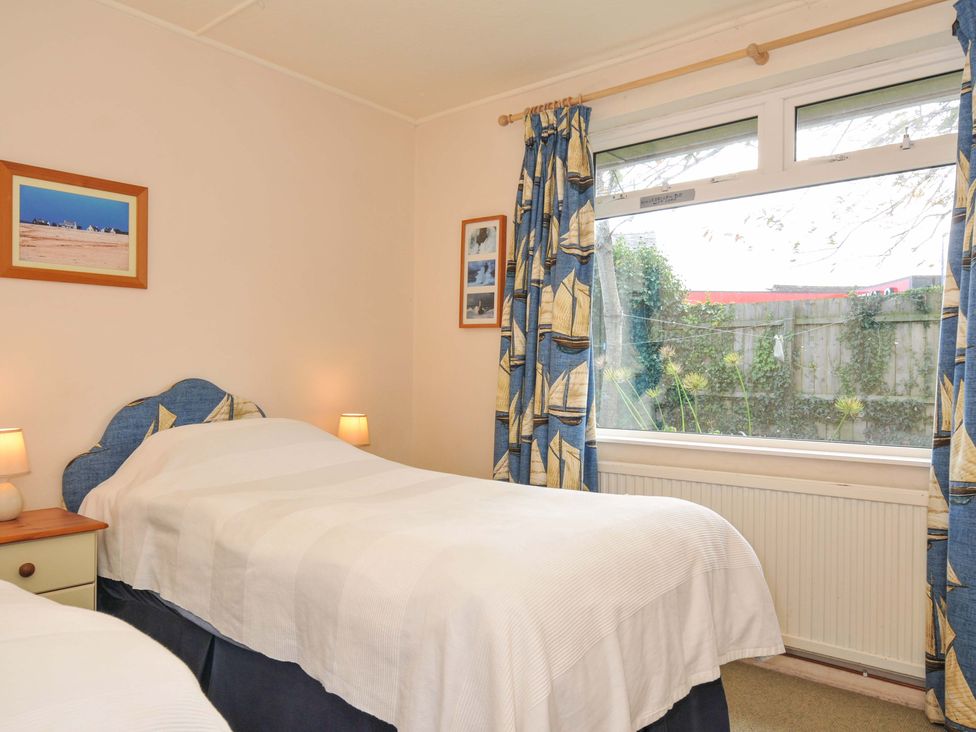 A bedroom with two single beds and a window at Avoca in Rock