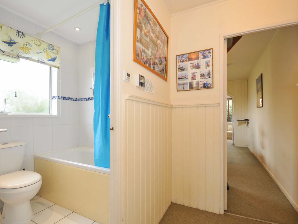 A bathroom with a shower, bathtub, and wall art at Avoca in Rock