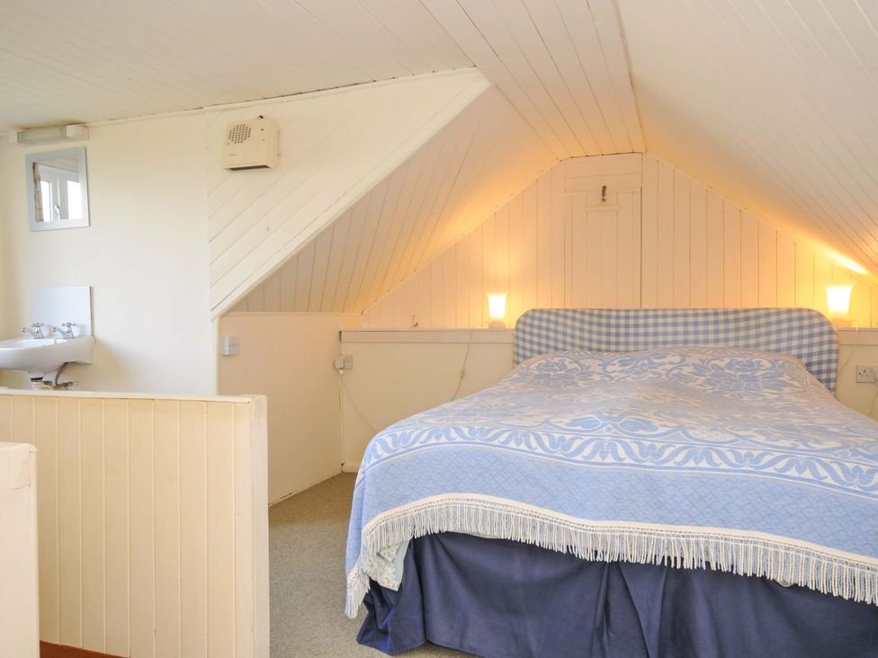 A bedroom with a bed and a sink at Avoca in Rock