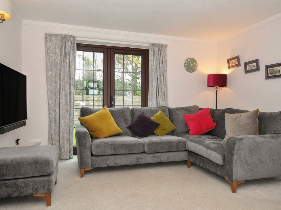 A living room with a sofa and television at Hazelhurst in Rock