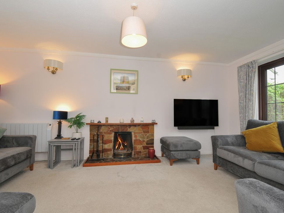 A living room with a fireplace and seating at Hazelhurst in Rock