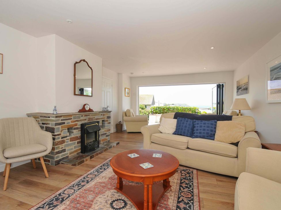 A living room with a sofa and coffee table at Sunset in Polzeath