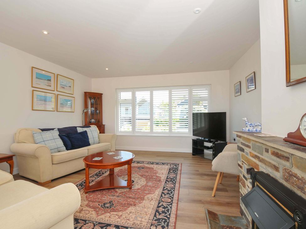 A living room with a sofa and coffee table at Sunset in Polzeath