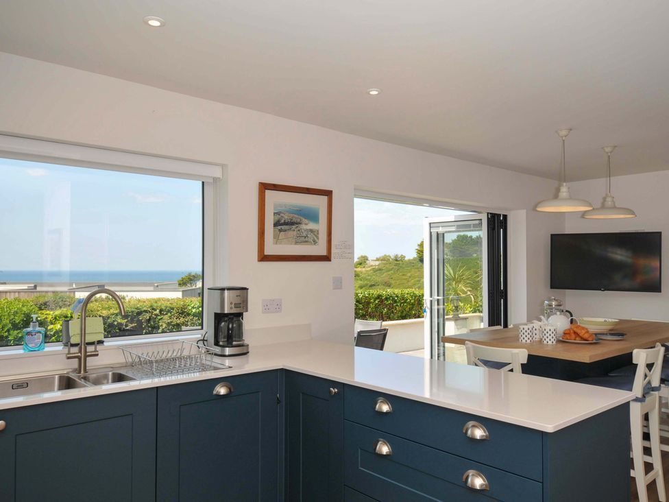 A kitchen with a sink and coffee maker at Sunset in Polzeath