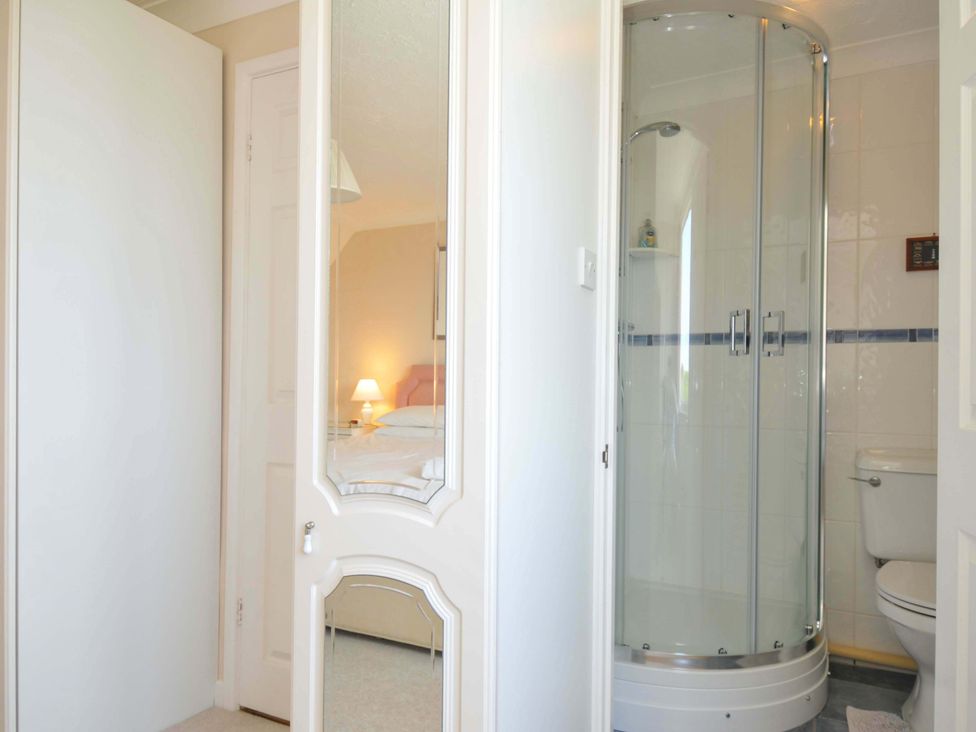 A bathroom with a shower and toilet at Sunset in Polzeath
