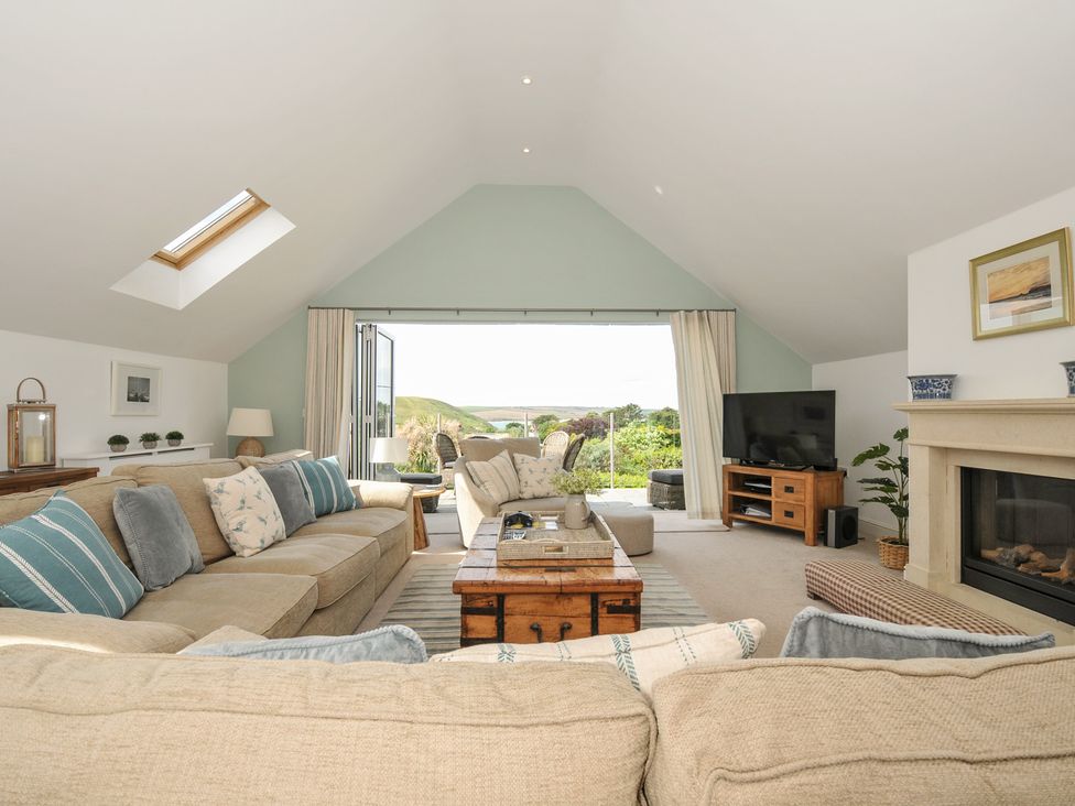 A living room with a sofa and coffee table at Farlands in Daymer Bay