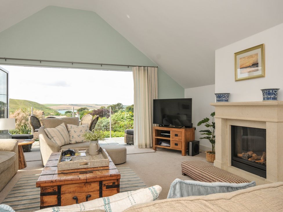 A living room with a television and a coffee table at Farlands Daymer Bay