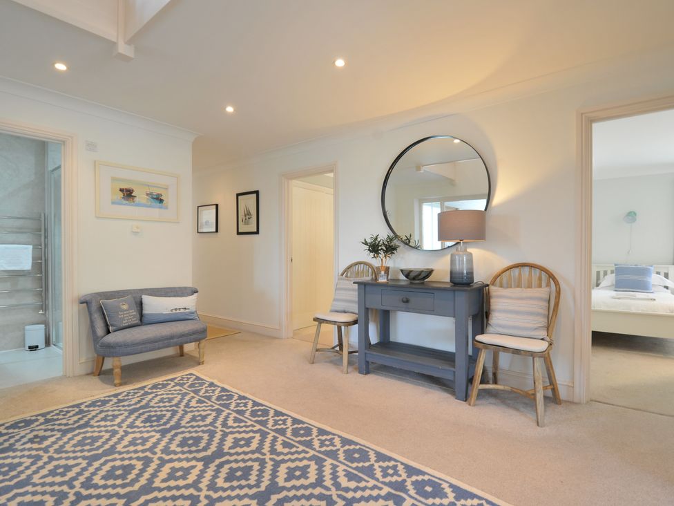 A hallway with a sofa and table at Farlands in Daymer Bay
