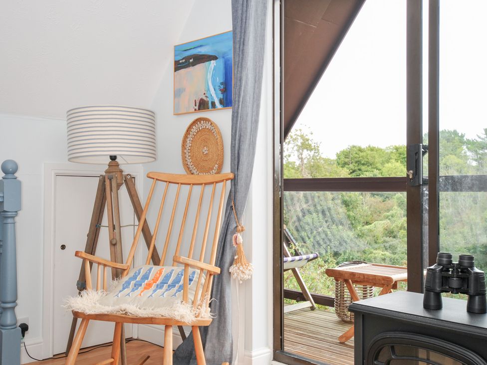 A living room with a rocking chair and a balcony view at Rocklings in Rock