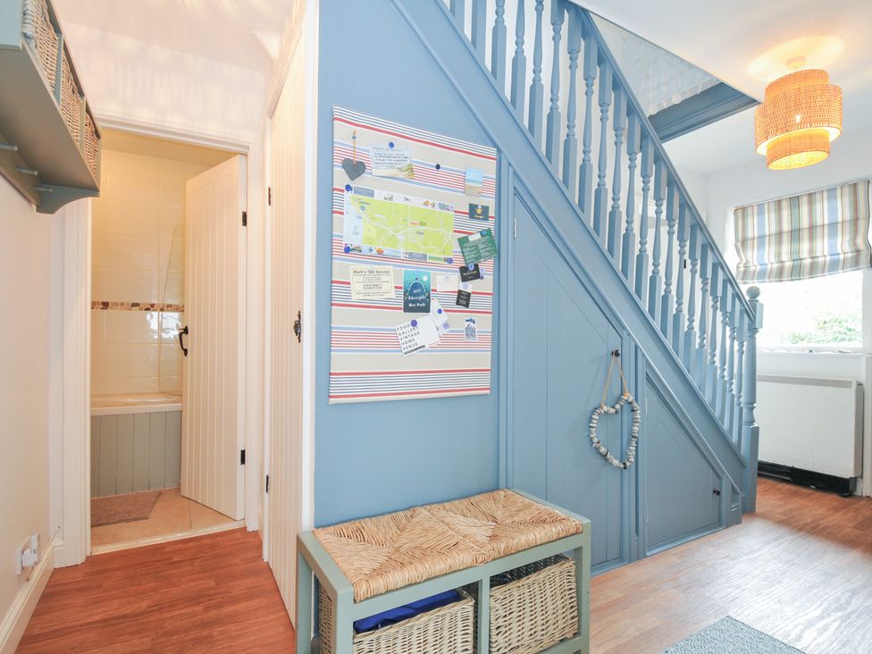 A hallway with a staircase and storage bench at Rocklings in Rock