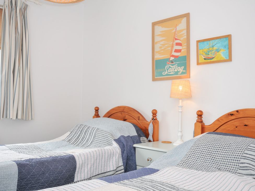 A bedroom with two beds and wall art in Rocklings, Rock