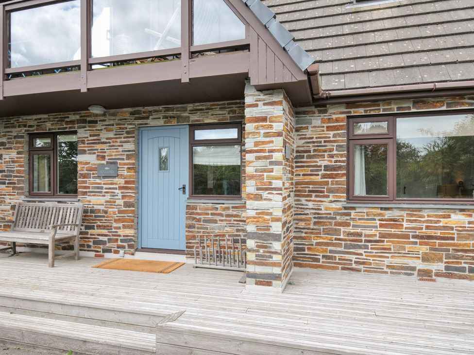 An entrance with a blue door and stone wall at Rocklings in Rock