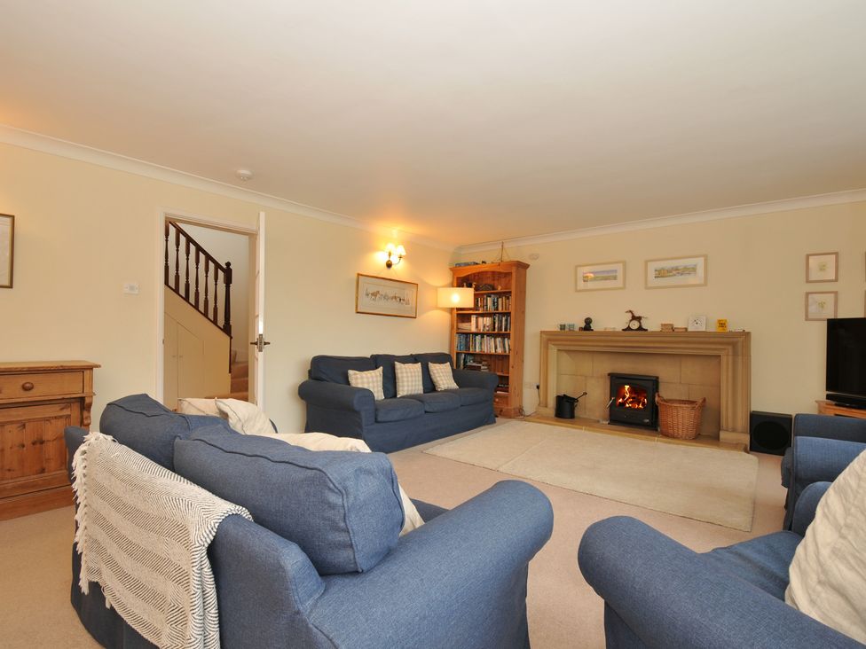 A living room with sofas and a fireplace at Tregillan in Rock