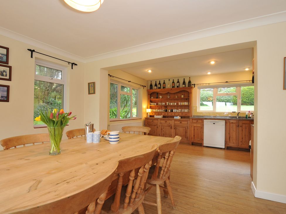 A kitchen with a large wooden table and chairs at Tregillan in Rock