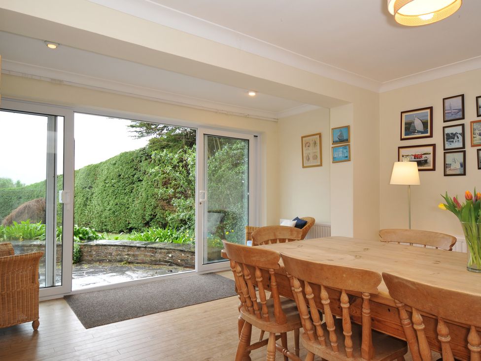 A dining room with a table and chairs at Tregillan in Rock