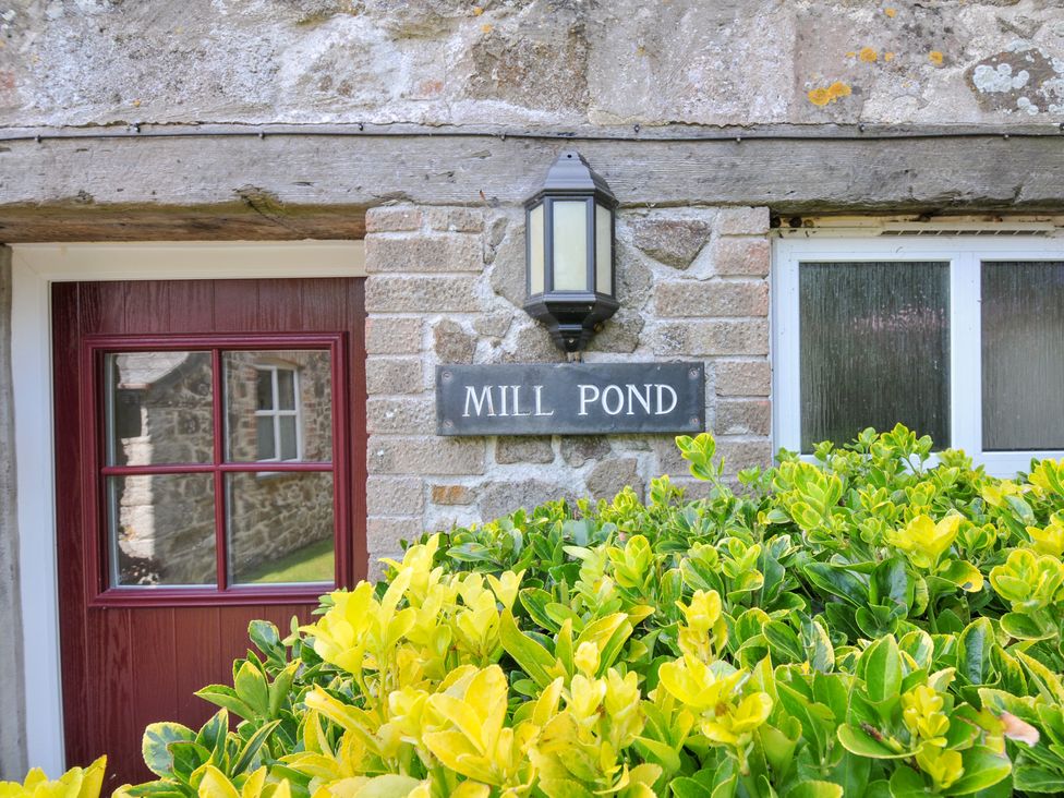 Exterior view of a building with a door and sign at Mill Pond in Rock
