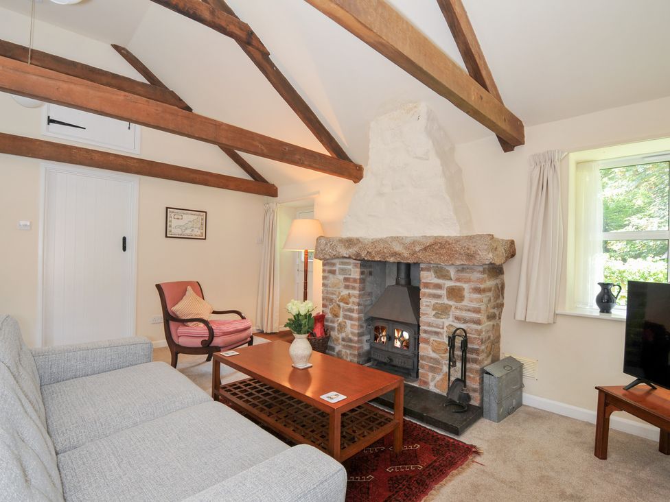 A living room with a fireplace and sofa at Mill Pond in Rock