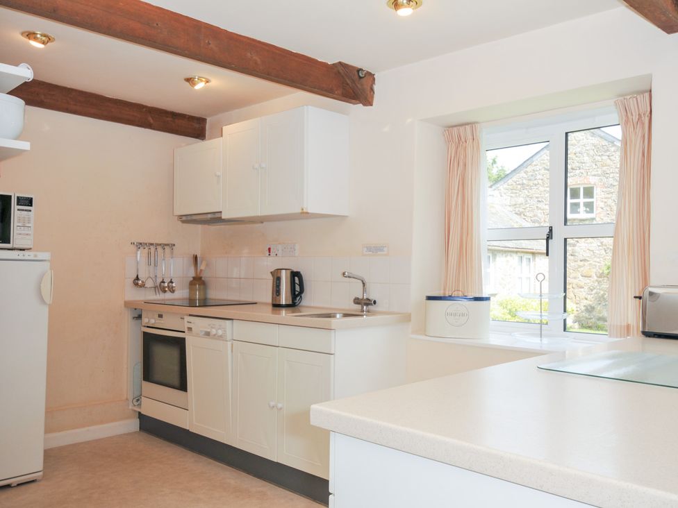 A kitchen with appliances and a window at Mill Pond in Rock