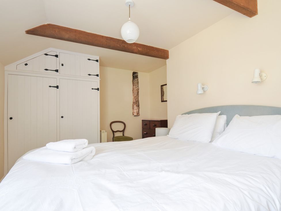 A bedroom with a bed and wardrobe at Mill Pond Rock
