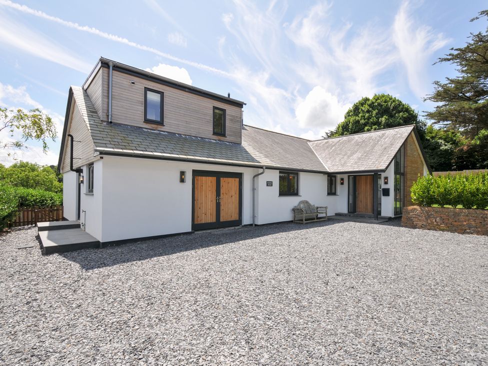 A house with a gravel driveway and outdoor seating at Porthilly Brook in Rock