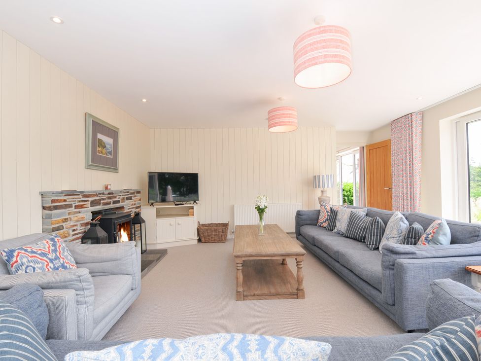 A living room with a coffee table and fireplace at Porthilly Brook in Rock
