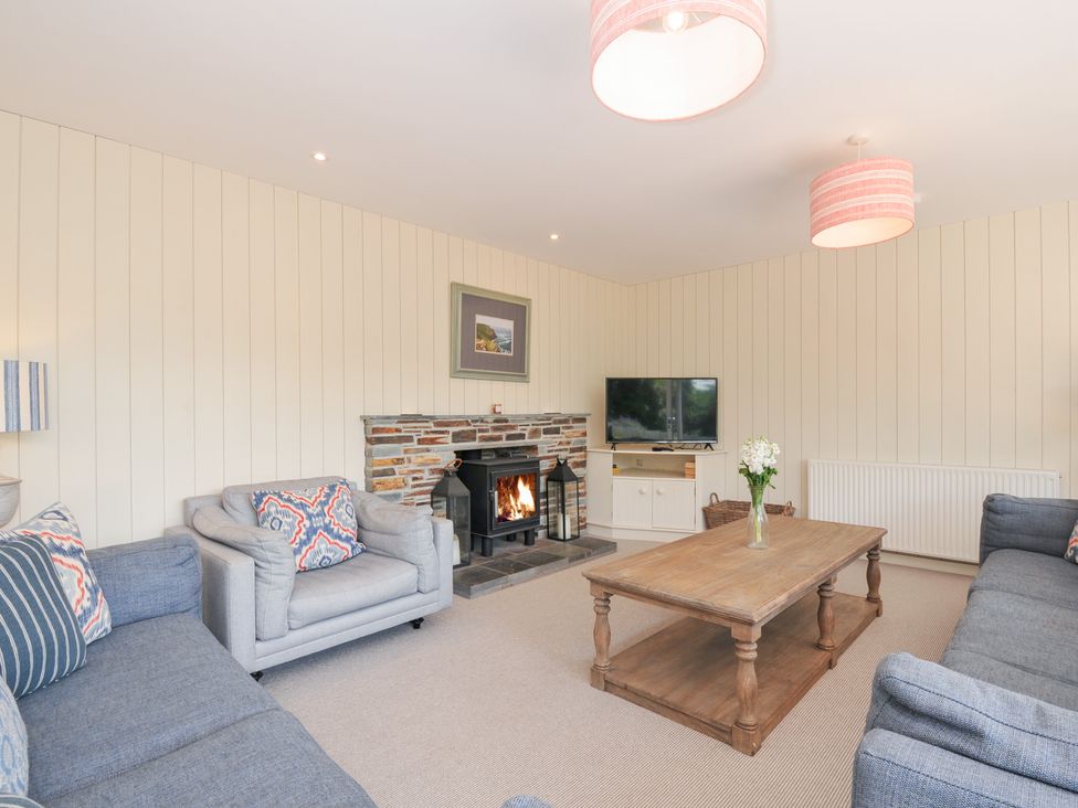 A living room with a coffee table and fireplace at Porthilly Brook in Rock