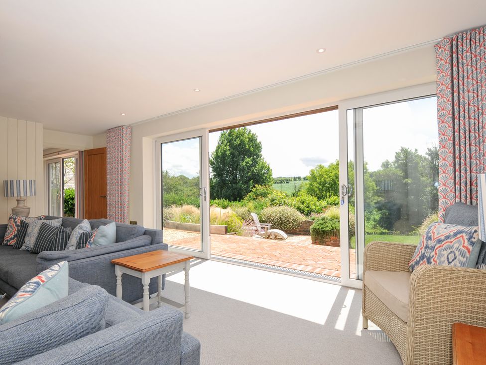 A living room with a sofa and armchair at Porthilly Brook in Rock