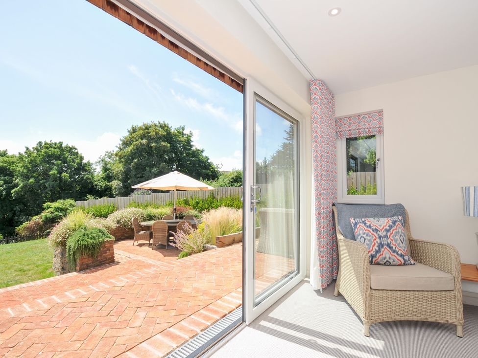 A living room with a view of the garden at Porthilly Brook in Rock